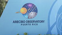 https://upload.media.orgikipedia/commons/thumb/d/d5/Arecibo_Observatory%2C_sign_at_entrance_gate.jpg/220px-Arecibo_Observatory%2C_sign_at_entrance_gate.jpg