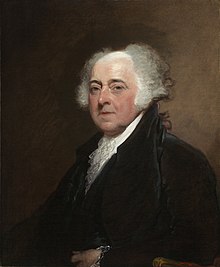 Stout elderly Adams in his 60s with long white hair, facing partway leftward